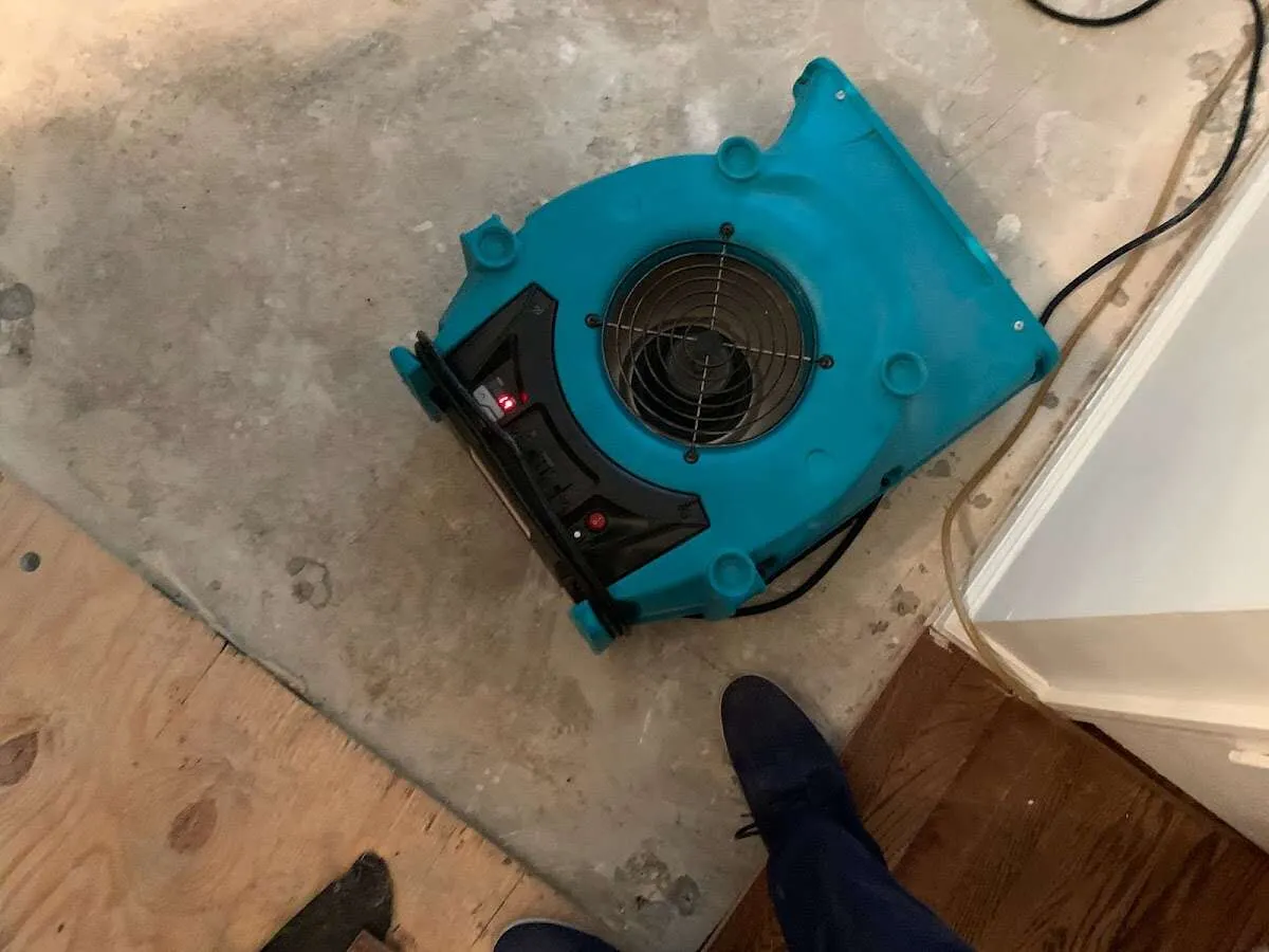 Air mover drying subfloor during Leak Detection & Repair in Barrington